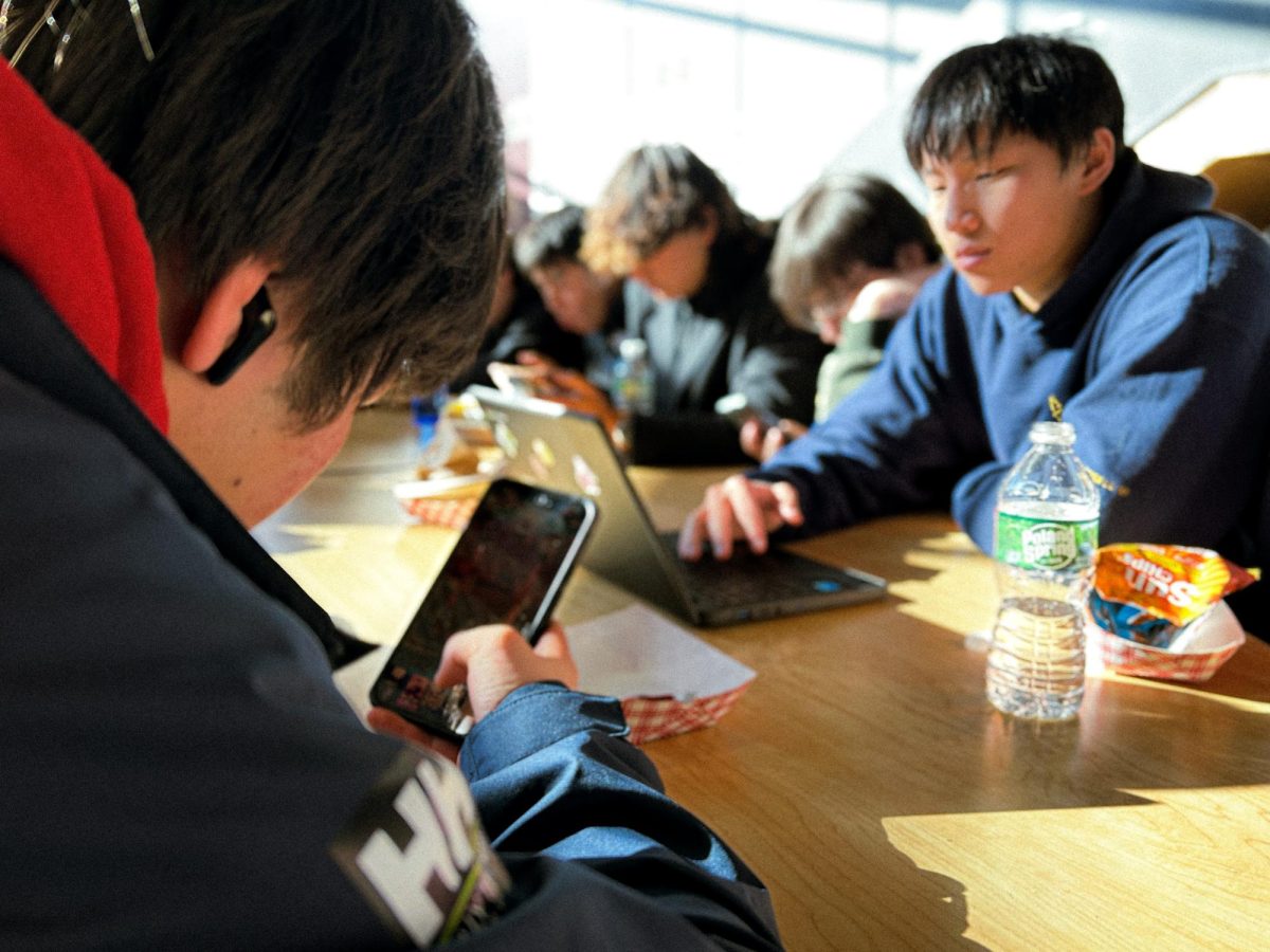 Students on their phones during lunch time at Sharon High School